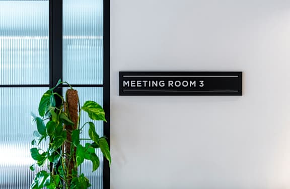 Sign on wall says meeting room 3 at The Lark, London