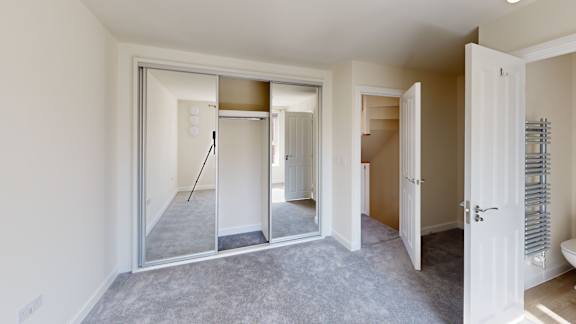 A room with a sliding door and a mirror.