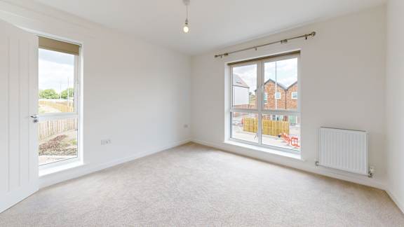 A room with a window overlooking a construction site.