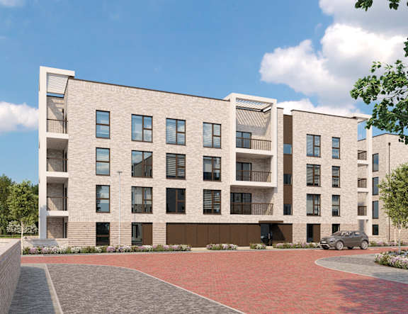 A modern apartment building with a brick driveway in front.