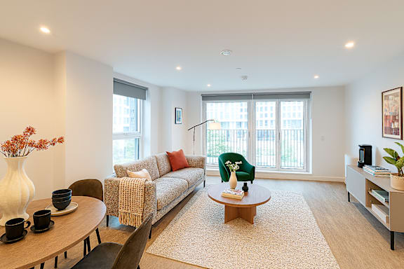 A living room with a sofa, a coffee table, and a chair.