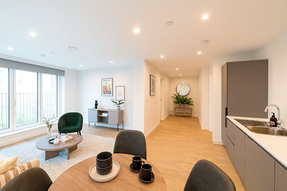 A modern dining room with a table set for two.