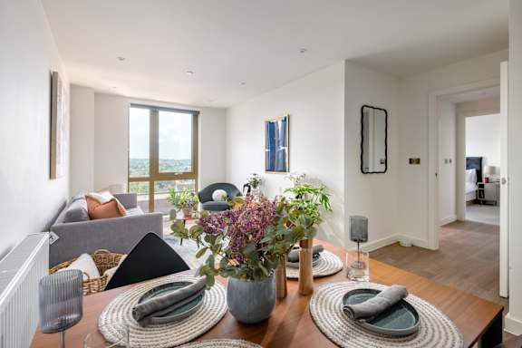 A modern dining room with a wooden table and chairs.
