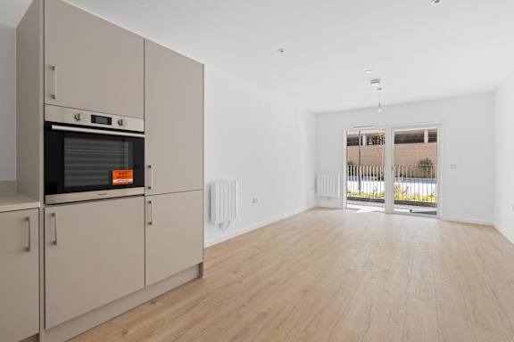 Kitchen with lounge at The Quarters Apartments, Dock Road