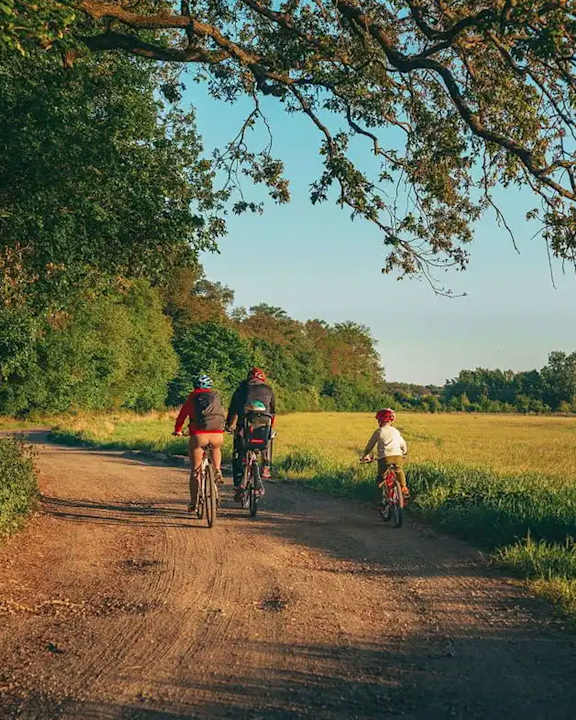 Three people riding bikes on a dirt road at Fernlow Apartments, Houghton Regis LU5 5GX
