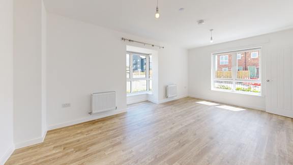 A room with wooden floors and white walls.