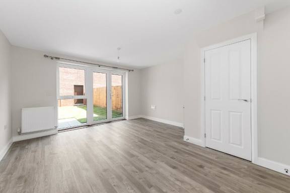 A room with a white door and a window with blinds at Origins Apartments, Cambridge, CB3 0UX