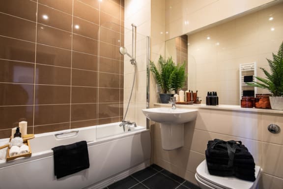 a bathroom with a sink toilet and bath tub at The Keel Apartments, Liverpool, L3 4GE