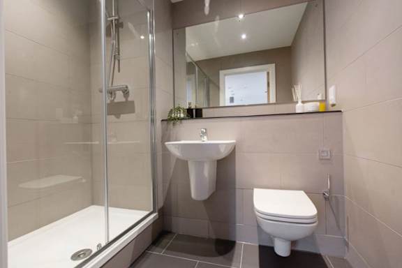 a bathroom with a toilet sink and shower a bathroom with a toilet sink and shower at Vox Apartments, Manchester, M15 4YD