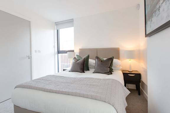 Bedroom with cozy bed Bedroom with cozy bed at Vox Apartments, Manchester