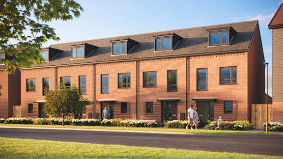 A red brick building with a green lawn in front.