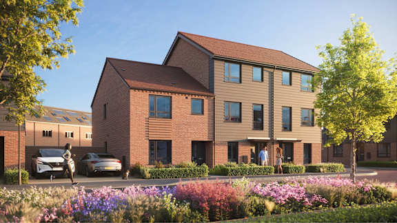 A modern brick house with a garden in front.