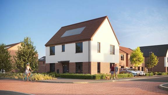 A modern house with a person riding a bicycle in front.