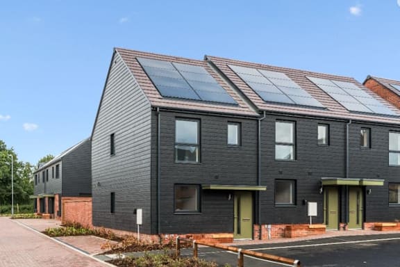 A modern house with solar panels on the roof.
