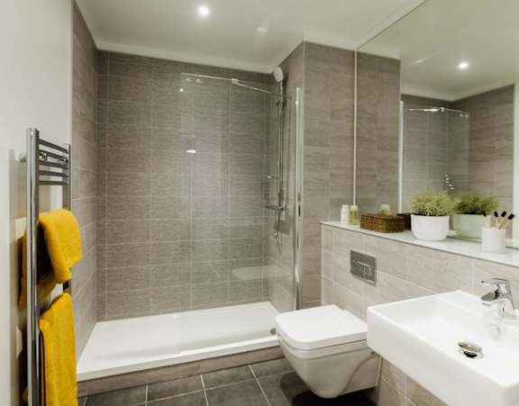 A bathroom with a toilet, sink, and shower. A bathroom with a toilet, sink, and shower.at Slate Yard Apartments, Salford, M3 5EX