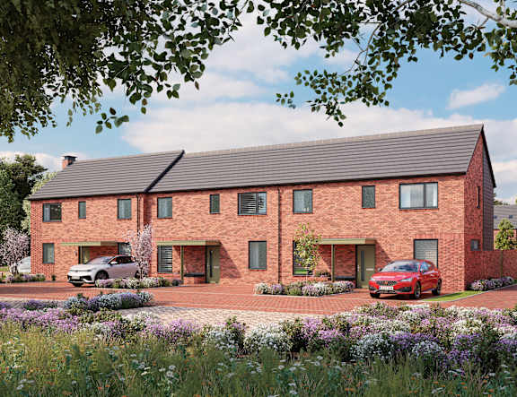 A red brick house with a car parked in front. at The Woodlands Apartments, Milton Keynes
