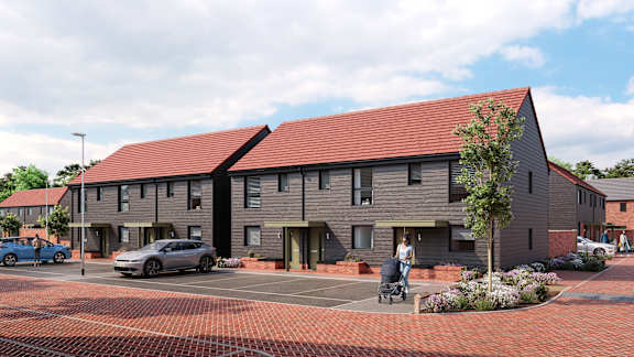 A modern building with a red roof and a brick driveway in front at The Woodlands Apartments, Milton Keynes, MK5 6GS