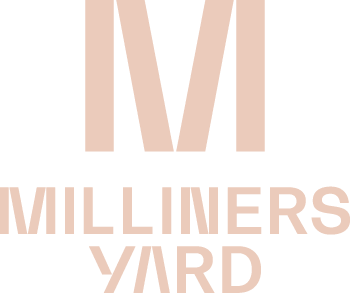 the logo for milliners yard in bold white and pink on a black background