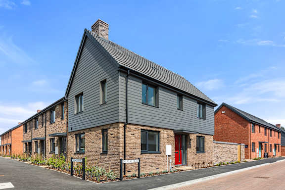 A row of houses with a clear blue sky above them.