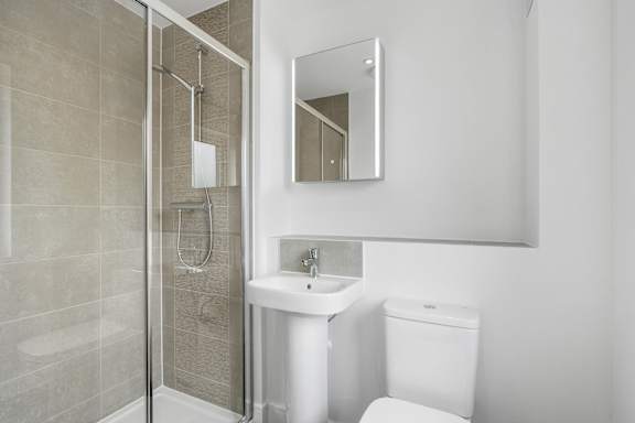 A white toilet sits next to a sink in a bathroom.