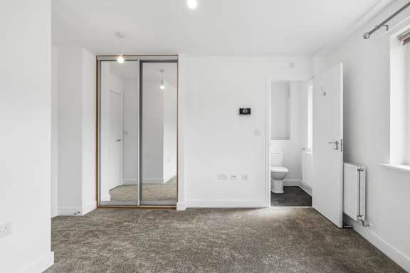 A bathroom with a toilet and a sink.