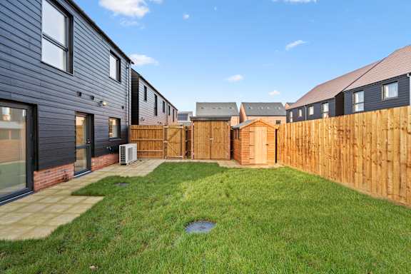 A row of houses with a wooden fence in front.
