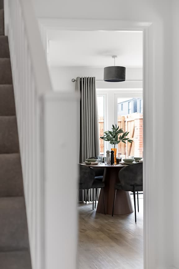 A dining room with a table set for two at The Woodlands Apartments, Milton Keynes, MK5 6GS