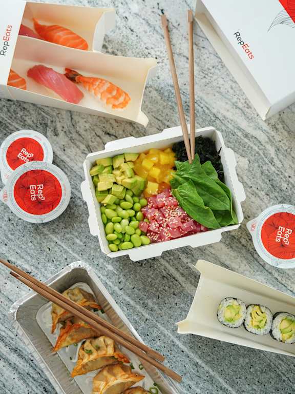 A variety of sushi and sashimi are displayed on a table.