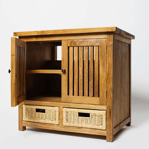 A wooden cabinet with a door open and two baskets underneath.