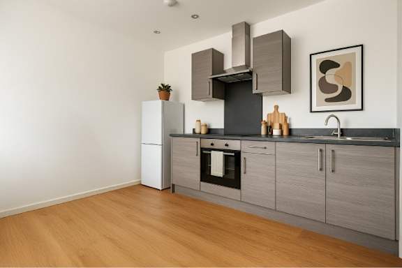 A modern kitchen with wooden floors and grey cabinets.