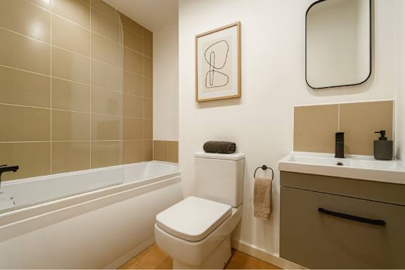 A bathroom with a toilet, sink, and bathtub.
