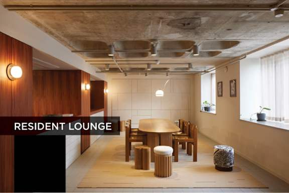 A resident lounge with a table and chairs.