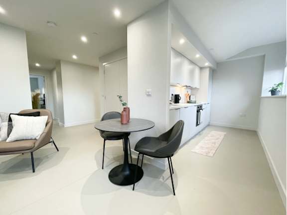 A modern dining area with a round table and chairs.