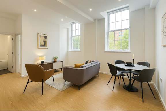 A living room with a brown chair and a brown couch.