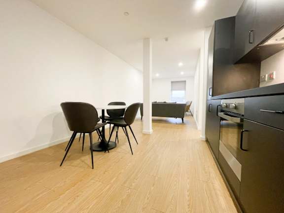 A kitchen with a table and chairs in the middle of the room.