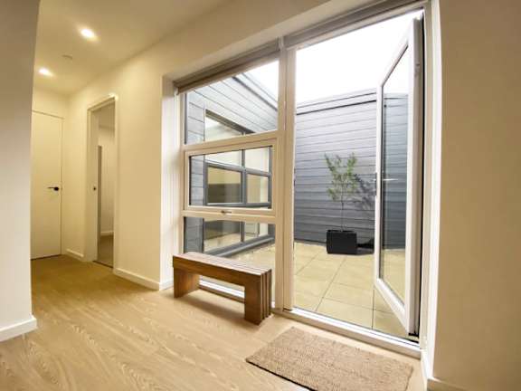 A room with a sliding glass door leading to a balcony.