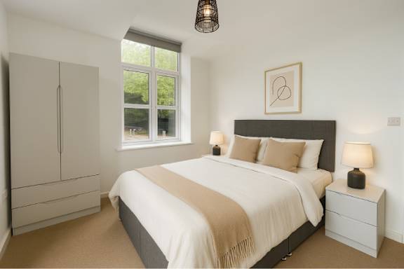 A bedroom with a large bed and a window.