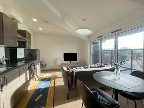 A modern kitchen with a dining table and chairs.