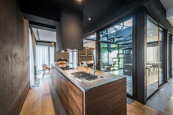 A modern kitchen with a wooden island and a view of the dining area.