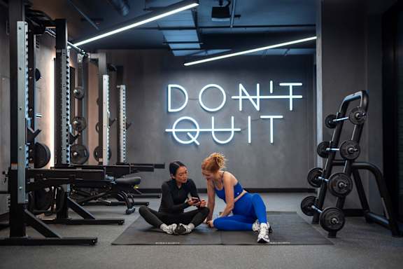 A gym with a neon sign that says "Don't Quit".