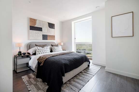 A bedroom with a large bed and a window.