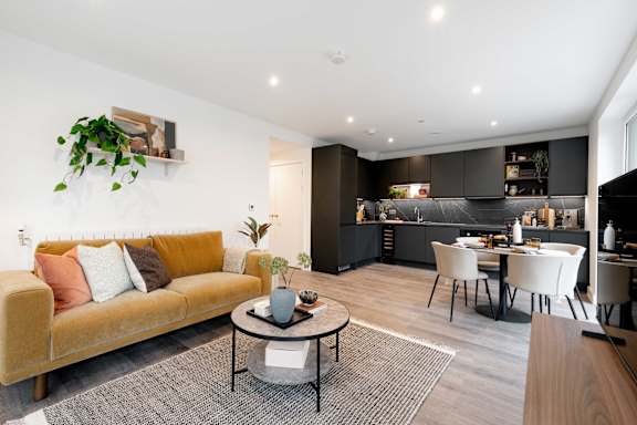 A modern living room with a yellow sofa and a grey coffee table.