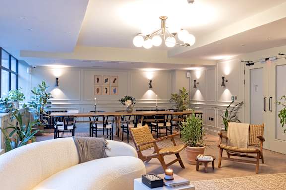 A living room with a sofa, chairs, and a dining table.