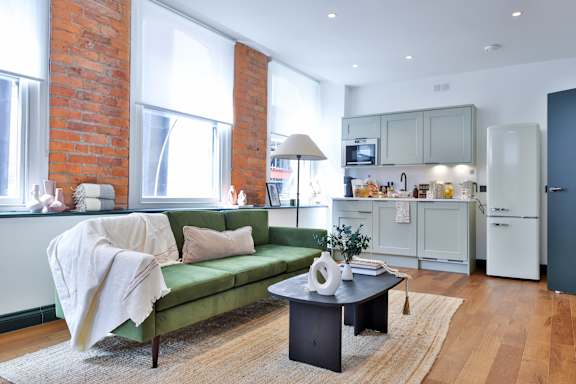 A living room with a green couch and a coffee table.