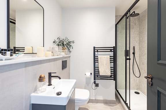 A bathroom with a white sink and a toilet.