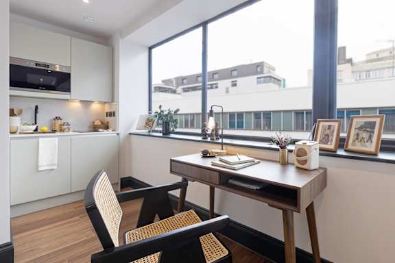 A modern kitchen with a dining table and chairs.