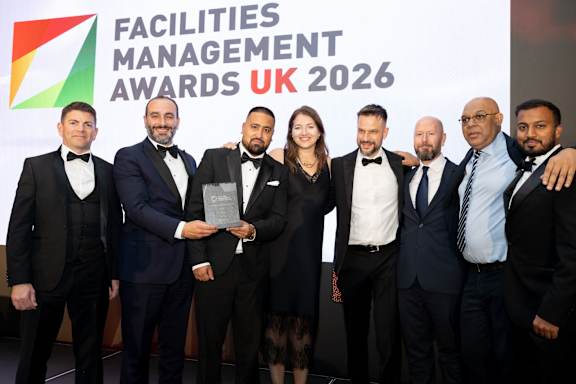 A group of people in formal attire are posing for a photo at the Facilities Management Awards UK 2026.