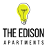 A yellow light bulb with a drawing of a pair of scissors on it.