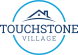 the logo for touchstone village with a house on top of a circle