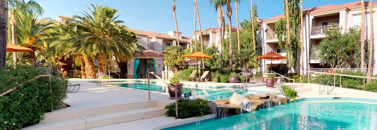 Pool and poolside area at Cortina Apartments.